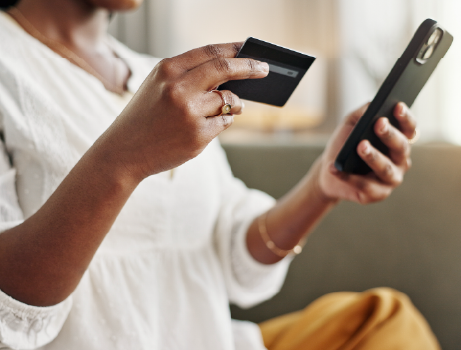 Person browsing on a mobile while checking their credit card information