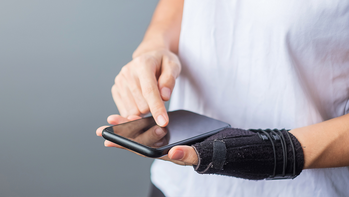 Man with broken wrist on phone