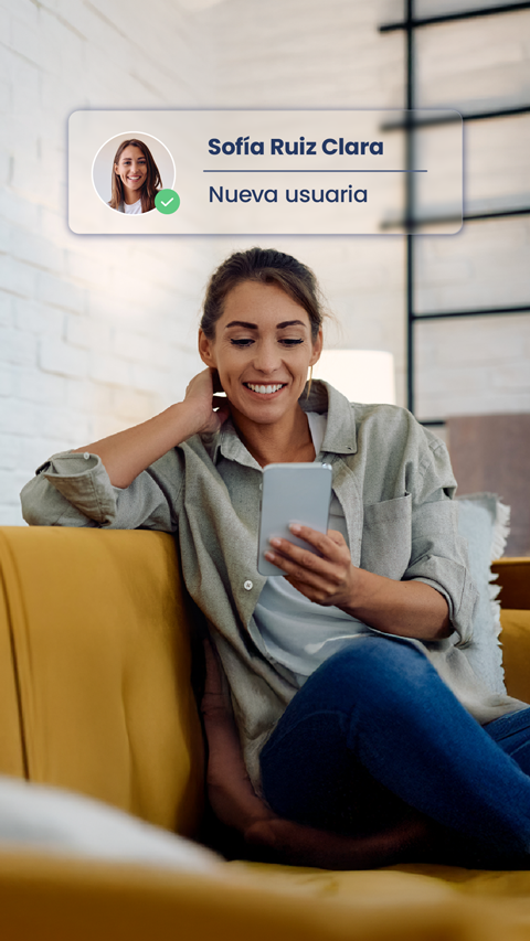User sitting on a sofa registering from her mobile device