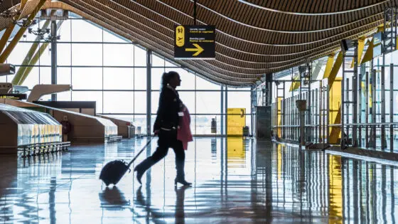 airport terminal with people moving silhouettes and sunray